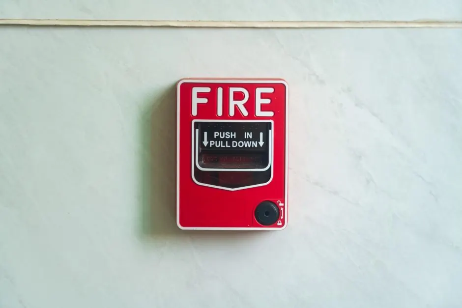Image of a wall mounted red fire alarm device for safety alerts and emergency preparedness.
