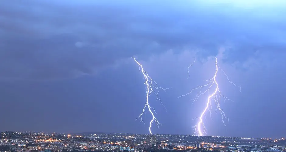 Stunning view of lightning striking over Johannesburg skyline at night, captivating nature's power.